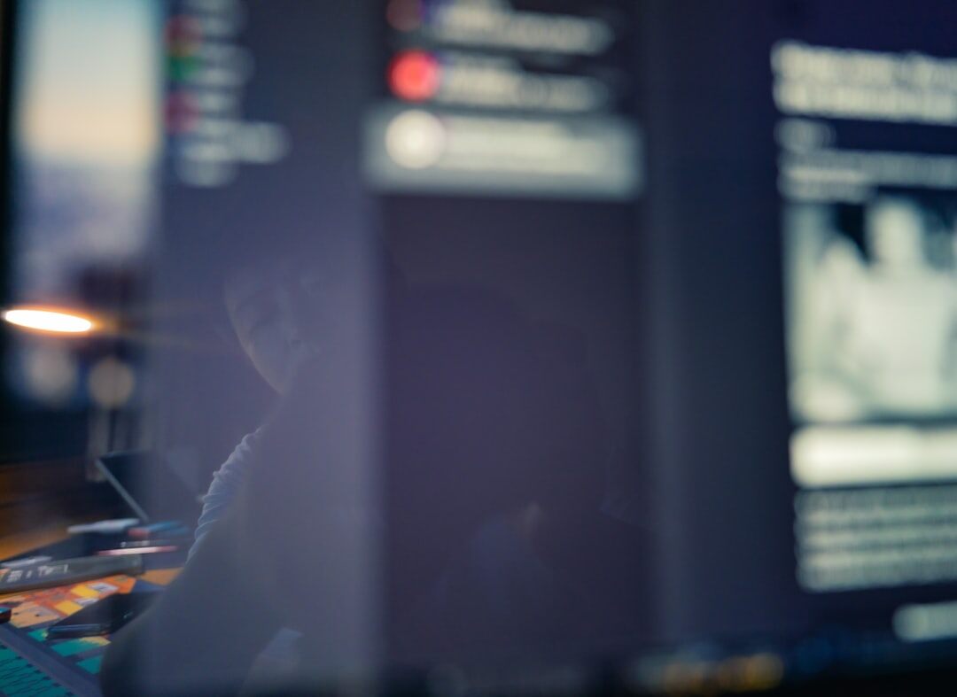 Journalist fact-checking sources on multiple screens